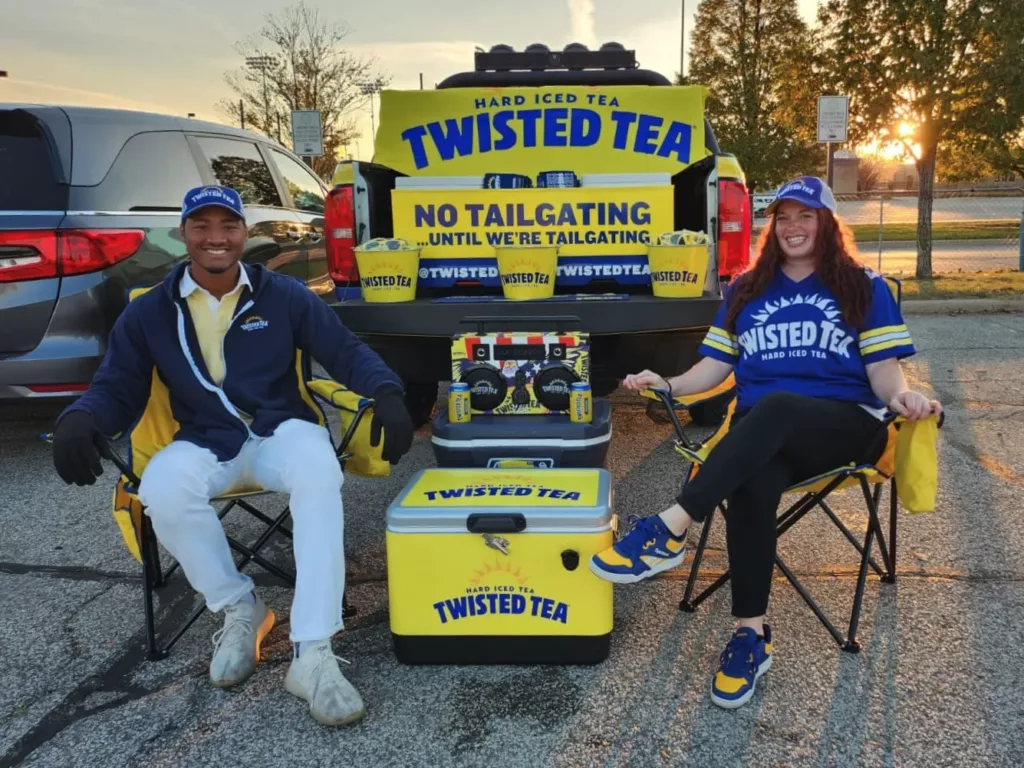 Two brand ambassadors in Twisted Tea shirts promoting the beverage with smiles